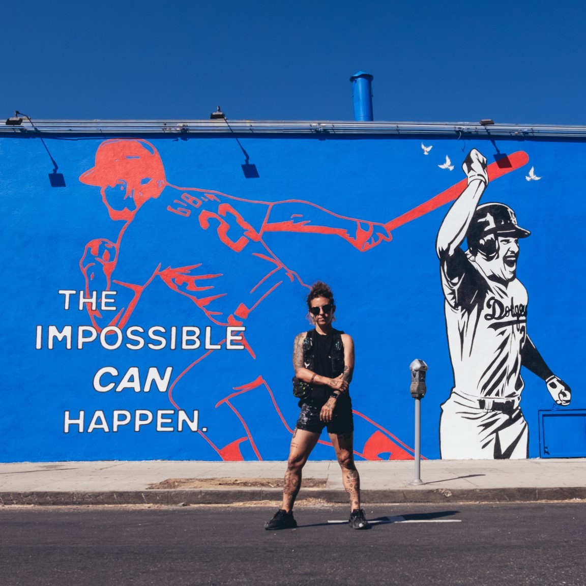 Corie Mattie in front of the mural on the Atwater building in LA.